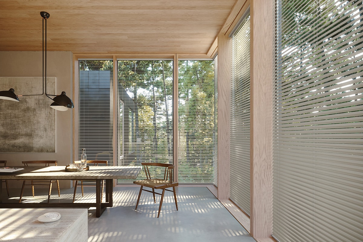 Aluminum Blinds filtering in natural sunlight into a open sleek dining room. 