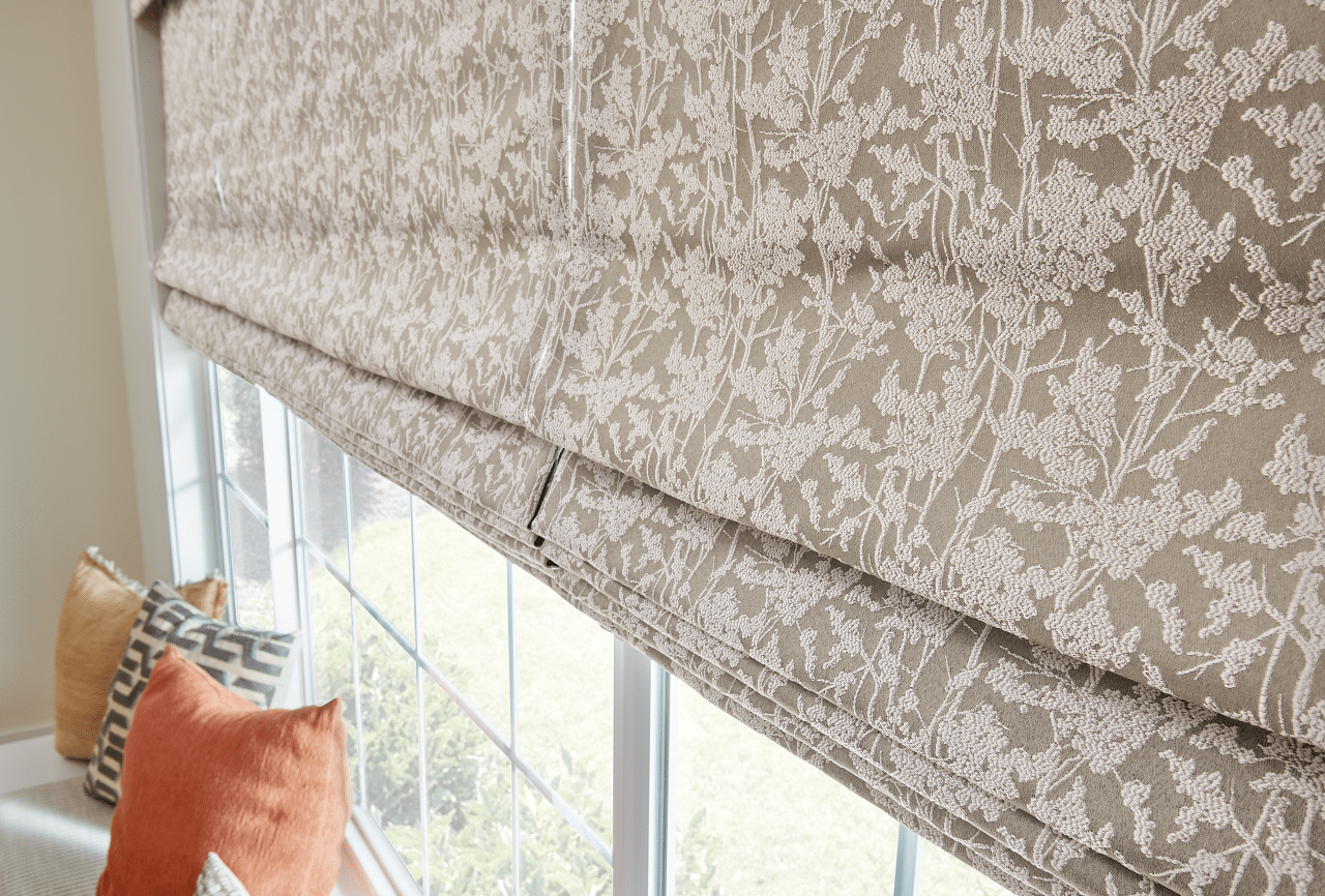 Brown and white patterned flower Roman shades filtering in light, in a Colorado Springs home.